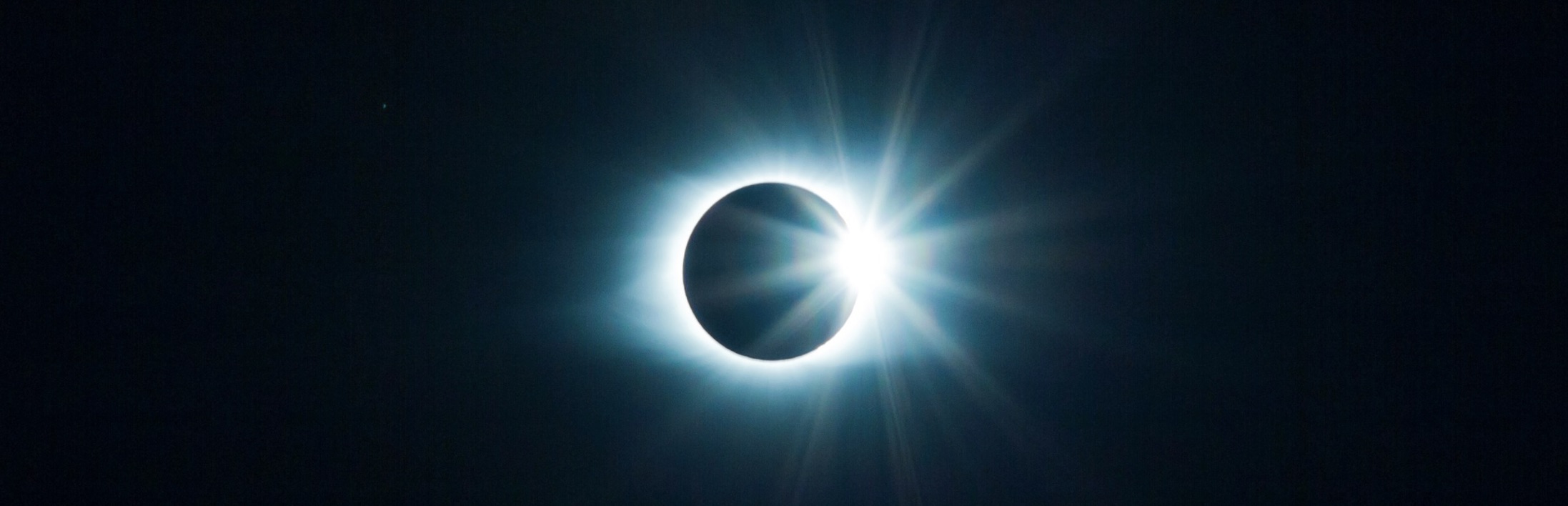 Total solar eclipse with glowing corona.